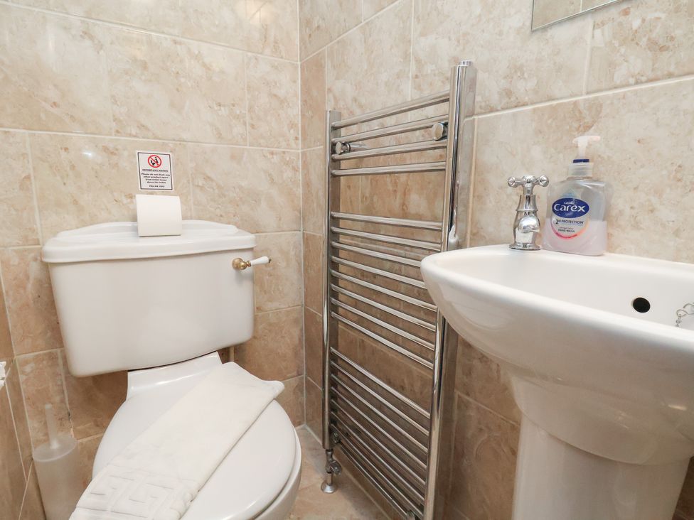A bathroom with a toilet and sink at Honeysuckle in Filey