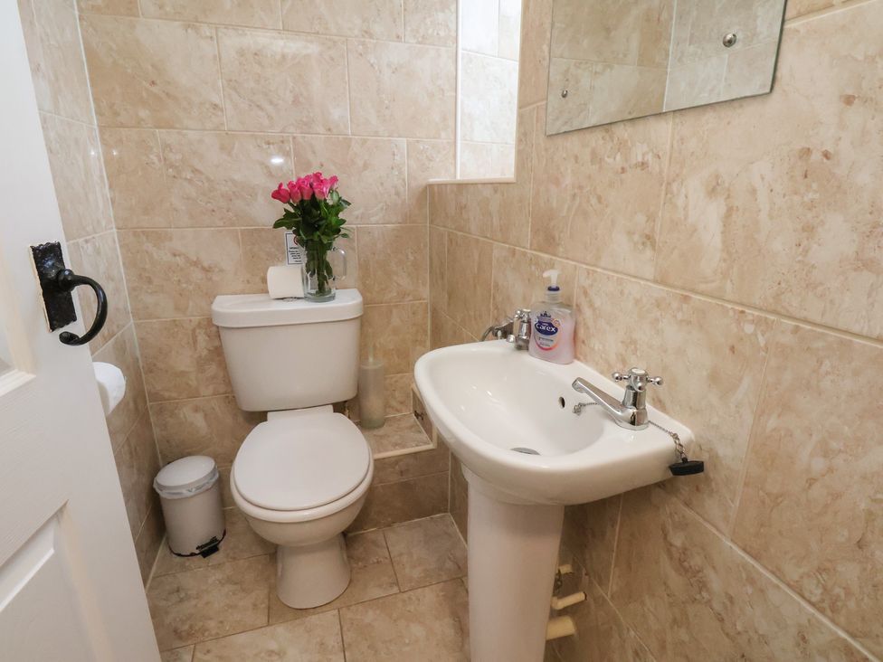 A bathroom with a toilet and sink at Honeysuckle in Filey