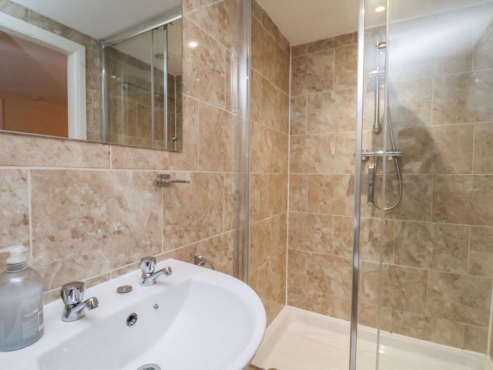 A bathroom with a shower and sink at Honeysuckle in Filey