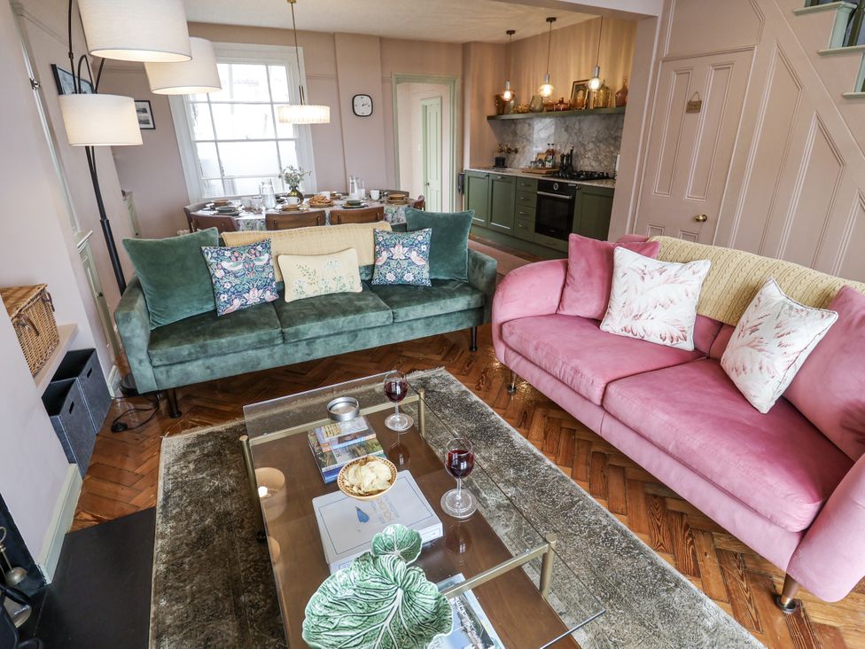 A living room with sofas and a dining area at Astondene, East Cliff, Southwold