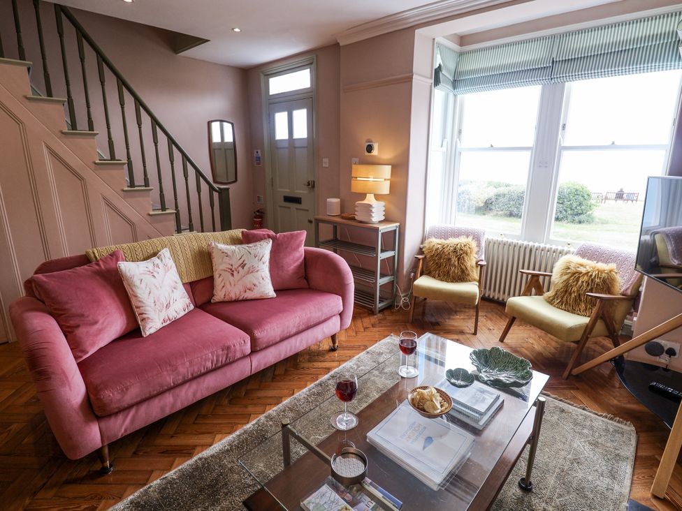 A living room with a sofa and armchairs at Astondene, East Cliff, Southwold