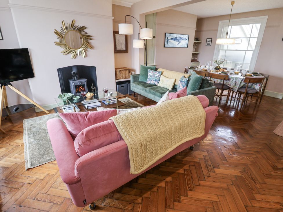 A living room with a sofa and coffee table at Astondene, East Cliff, Southwold