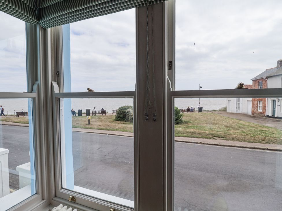 A view of the ocean and benches from a living room window at Astondene, East Cliff in Southwold