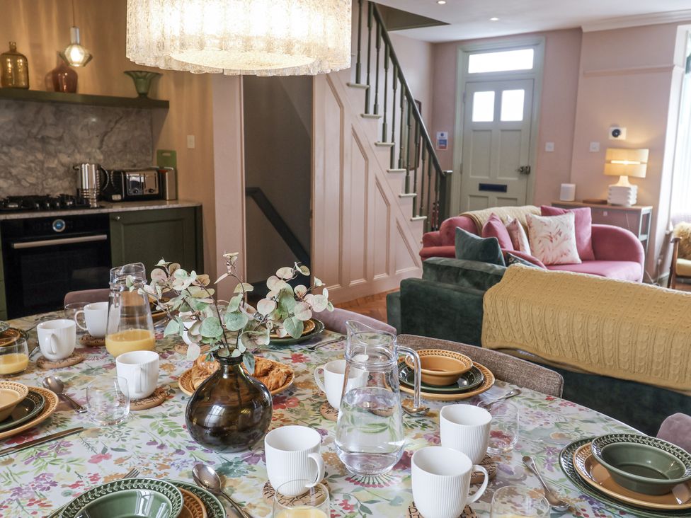 A dining room with a table set for breakfast at Astondene, East Cliff in Southwold
