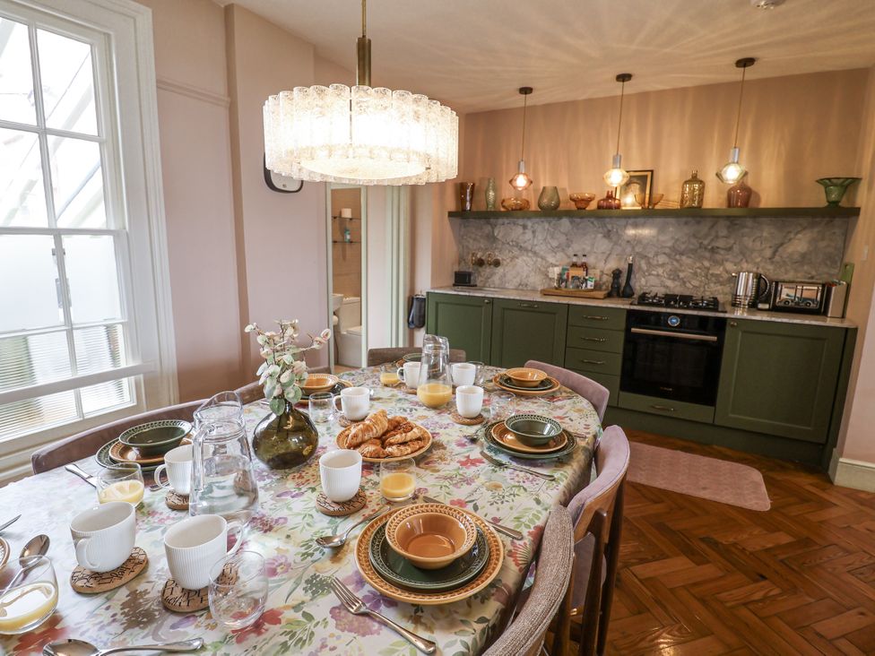 A dining table set with plates and drinks at Astondene, East Cliff in Southwold