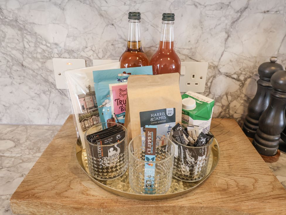 A kitchen counter with drinks and snacks at Astondene, East Cliff in Southwold