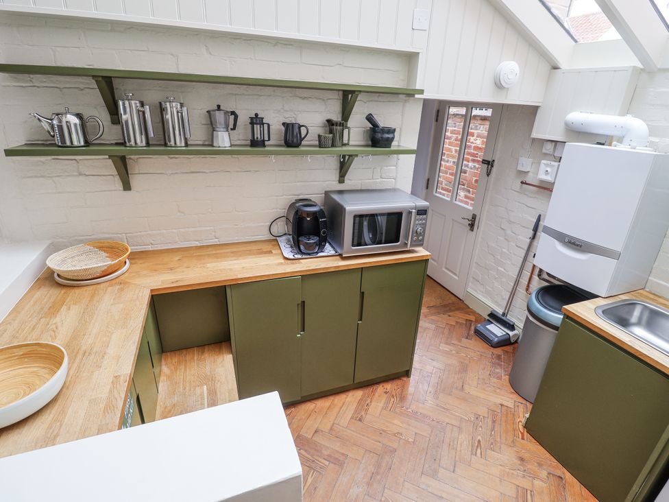 A kitchen with a microwave and coffee maker at Astondene, East Cliff in Southwold