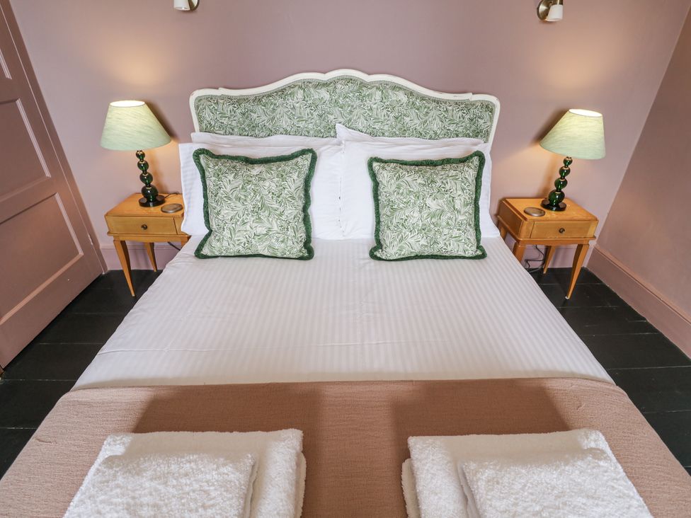 A bedroom with a bed and bedside tables at Astondene, East Cliff in Southwold
