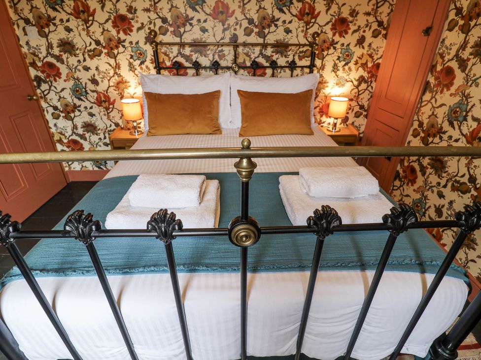 A bedroom with a bed and lamps at Astondene, East Cliff in Southwold