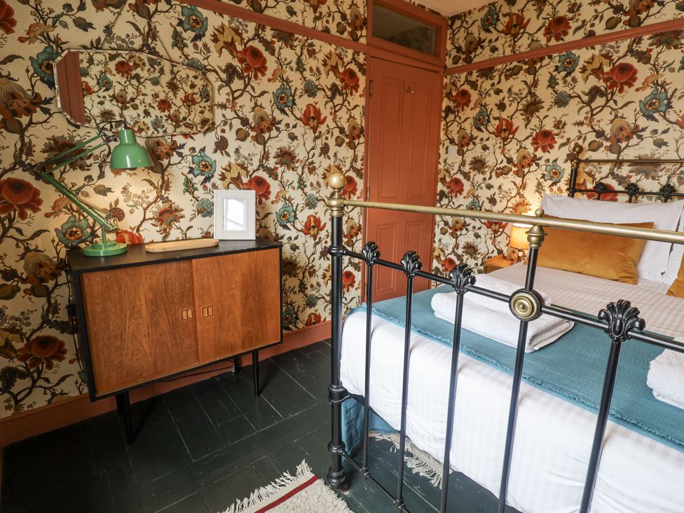 A bedroom with a bed and decorative items at Astondene, East Cliff, Southwold