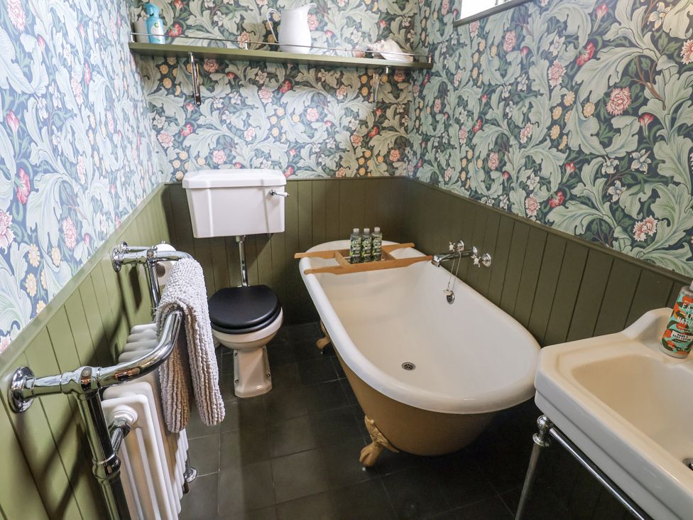 A bathroom featuring a bathtub, toilet, and sink at Astondene, East Cliff Southwold