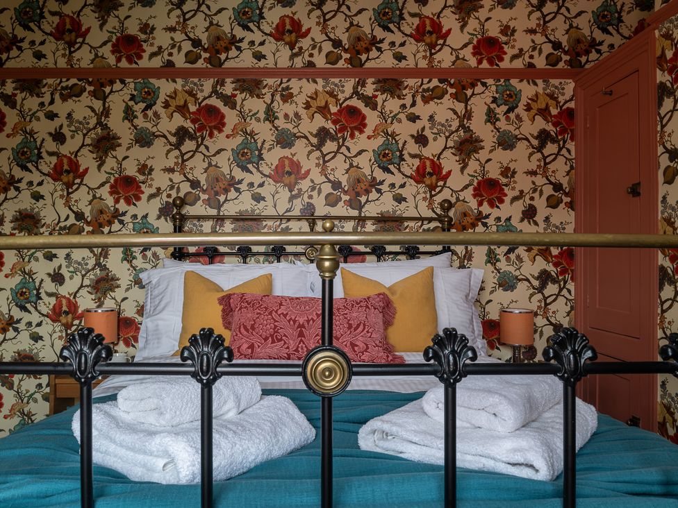 A bedroom with a bed and pillows at Astondene, East Cliff Southwold