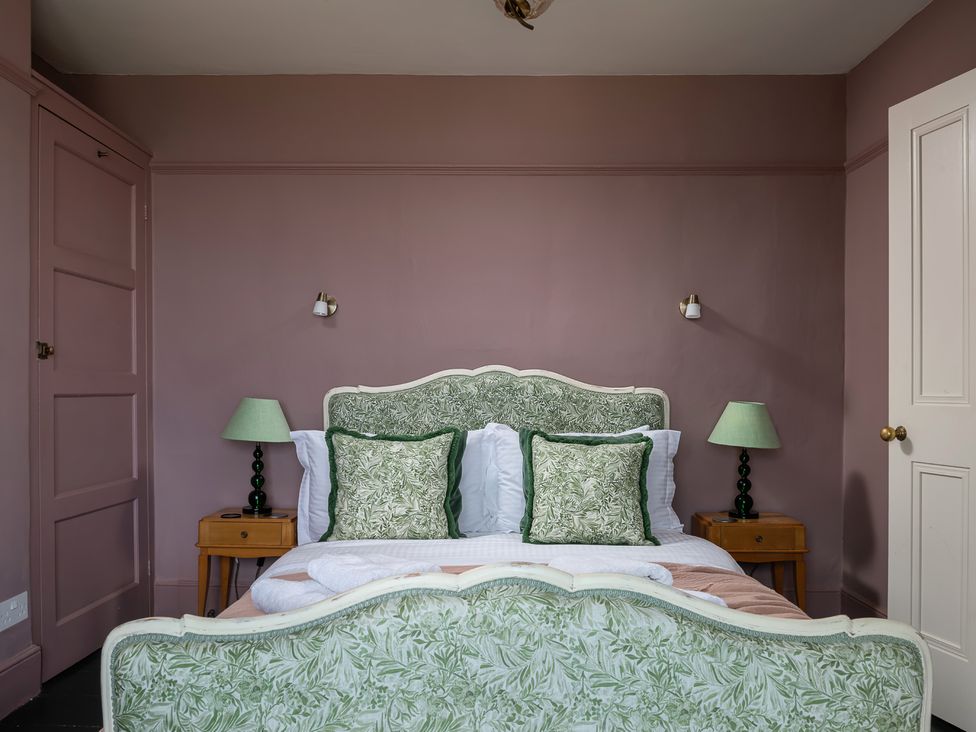 A bedroom with a bed and lamps at Astondene, East Cliff in Southwold