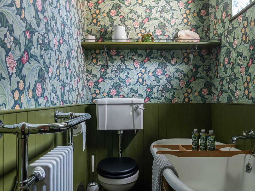 A bathroom with a bathtub and toilet at Astondene, East Cliff in Southwold