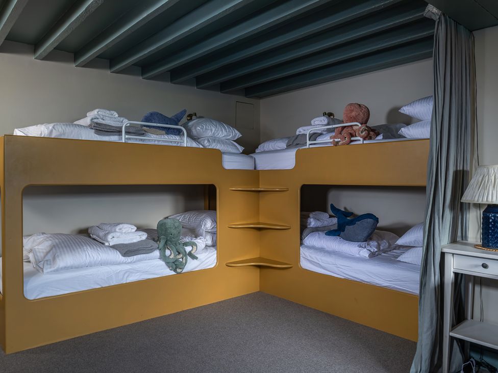 A bedroom with bunk beds and toys at Astondene, East Cliff Southwold