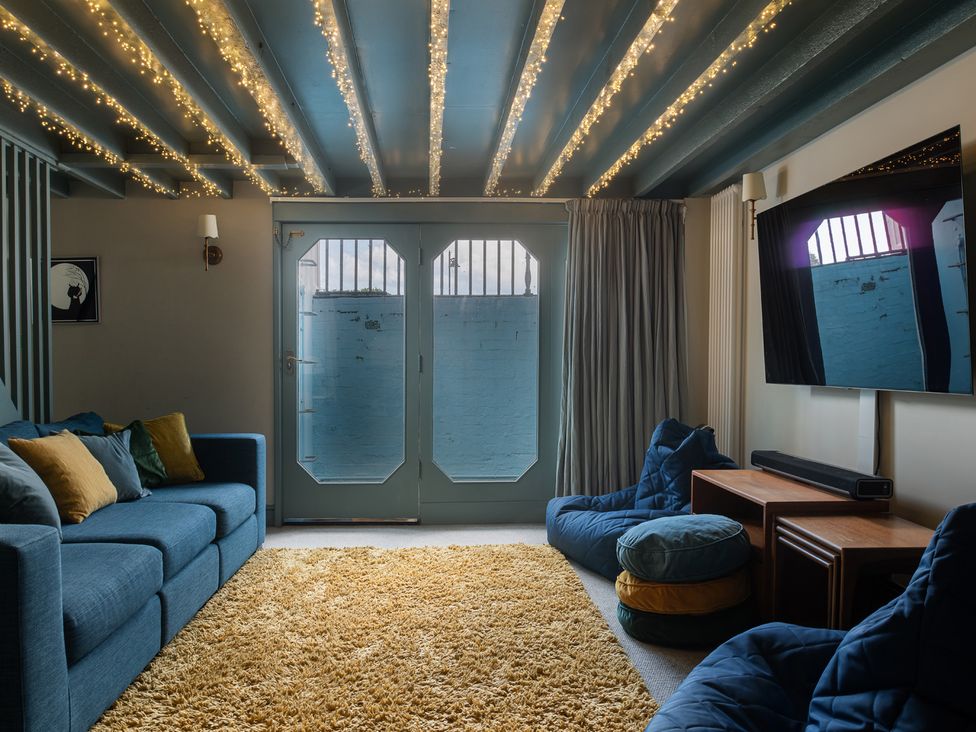 A living room with sofa and bean bags at Astondene, East Cliff