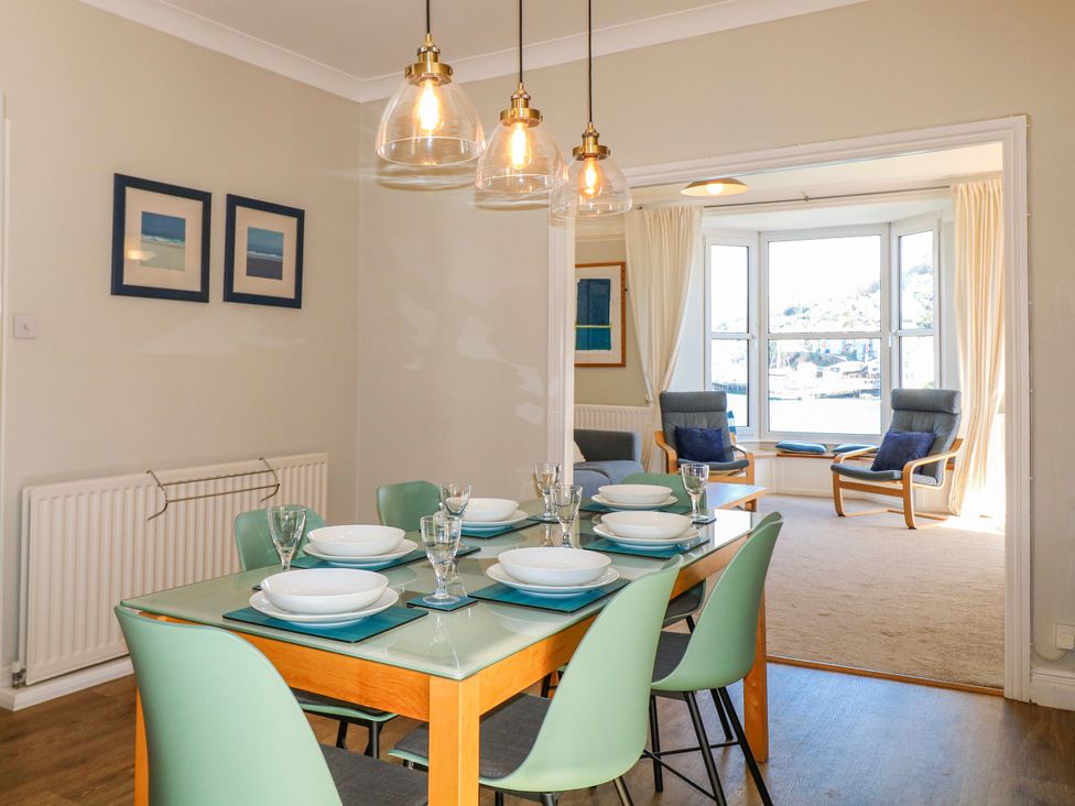 A dining room with a table set for dinner at Harbourside Dartmouth