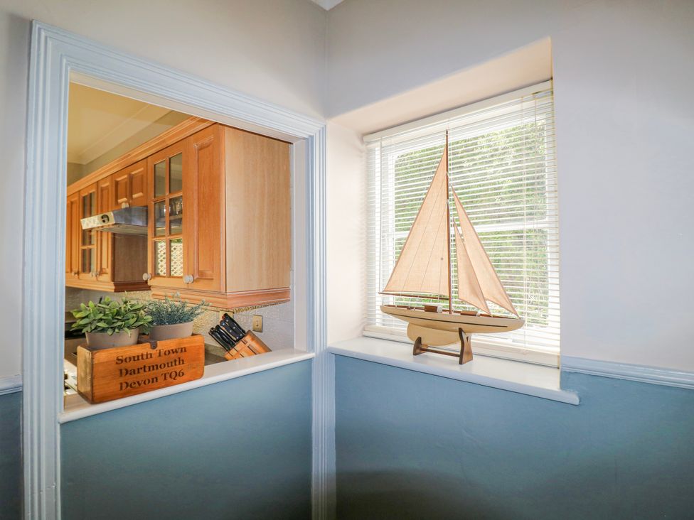 A kitchen with a window and a sailing boat at Harbourside Dartmouth