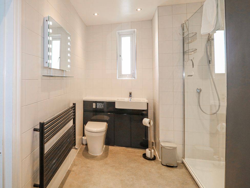 A bathroom with a sink, toilet, and shower at Harbourside in Dartmouth