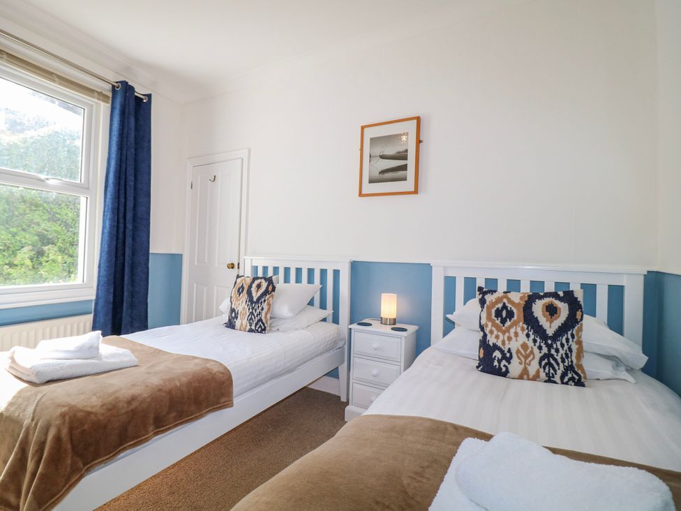 A bedroom with two beds and a window at Harbourside in Dartmouth