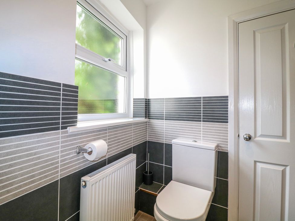 A bathroom with a toilet and radiator at Harbourside, Dartmouth
