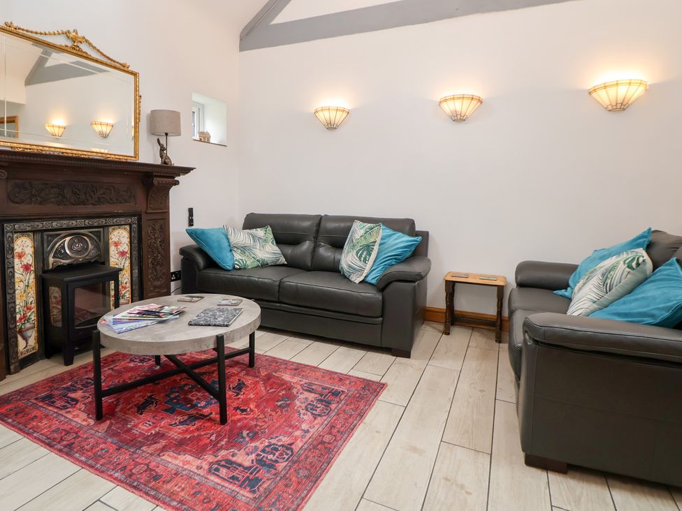 A living room with two sofas and a coffee table at The Stables in Chester