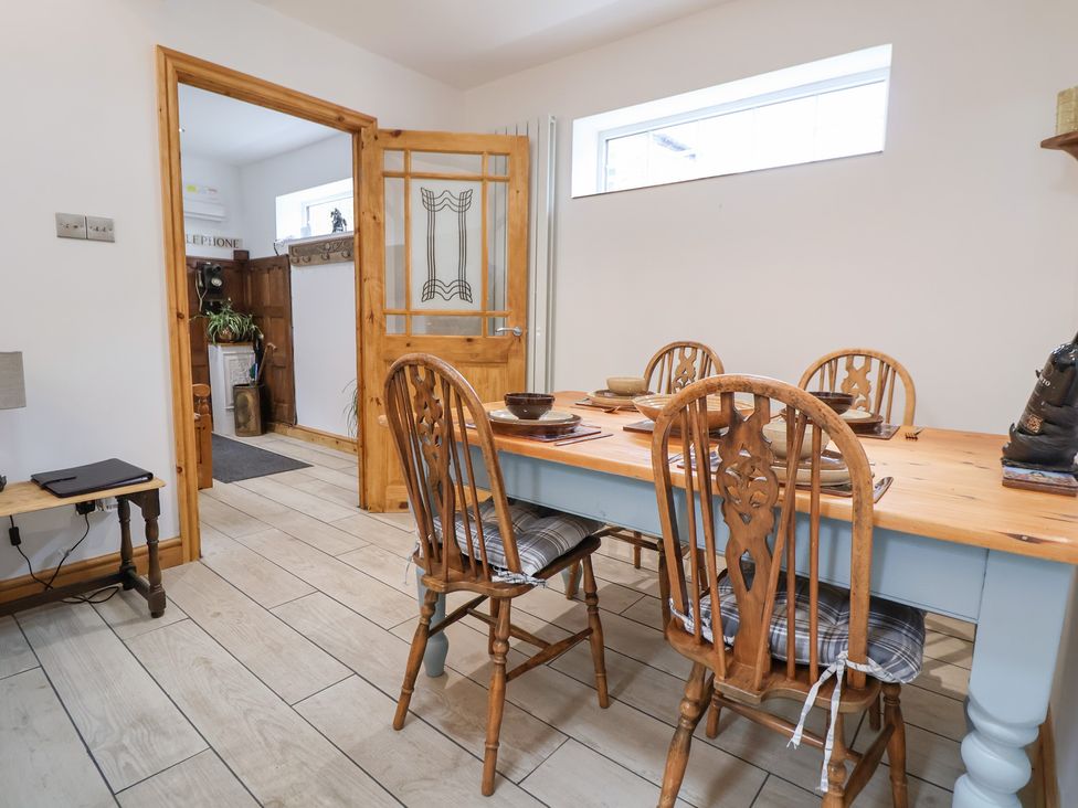 A dining room with a table and chairs at The Stables in Chester