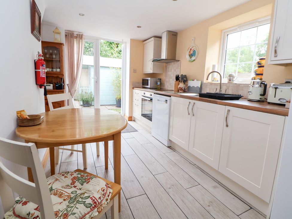 A kitchen with a table and chairs at The Stables in Chester