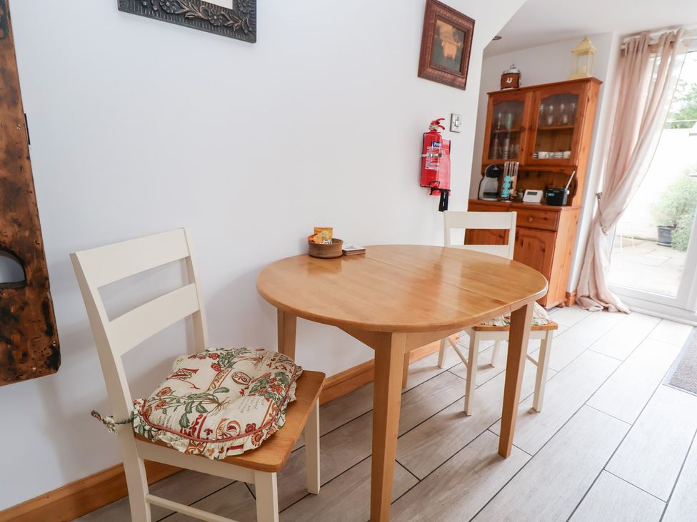 A dining room with a round table and chairs at The Stables in Chester