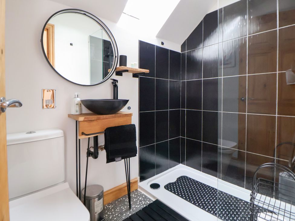 A bathroom with a sink, toilet and shower at The Stables in Chester
