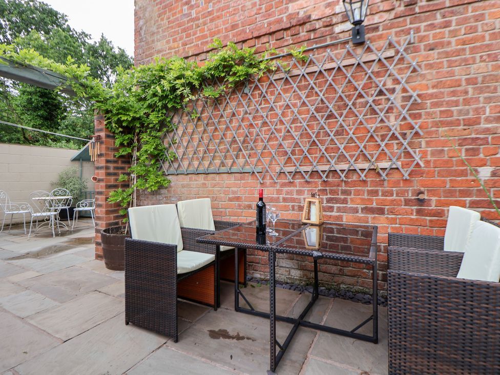 Outdoor patio with a table and chairs at The Stables in Chester
