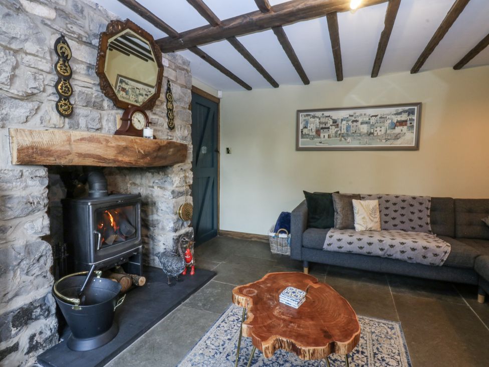 A living room with a fireplace and a couch at Windyridge in Gwaenysgor, near Prestatyn