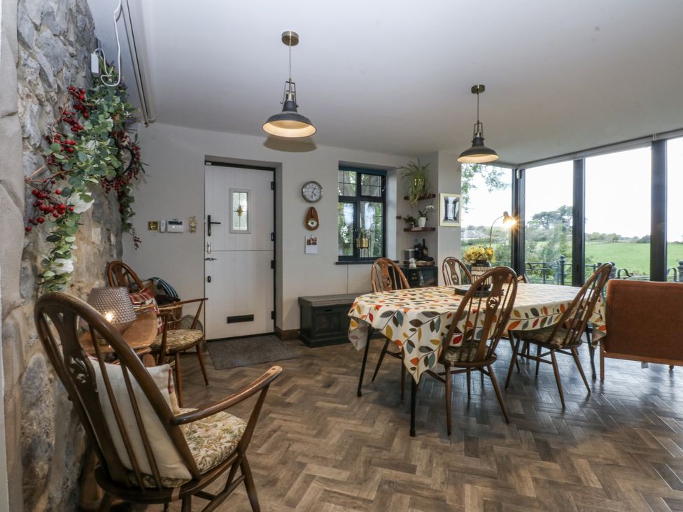 A dining room with a table and chairs at Windyridge, Gwaenysgor, near Prestatyn