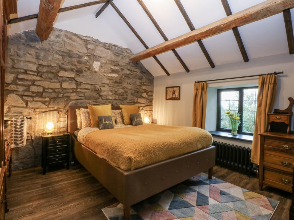 A bedroom with a bed and nightstand at Windyridge in Gwaenysgor, near Prestatyn