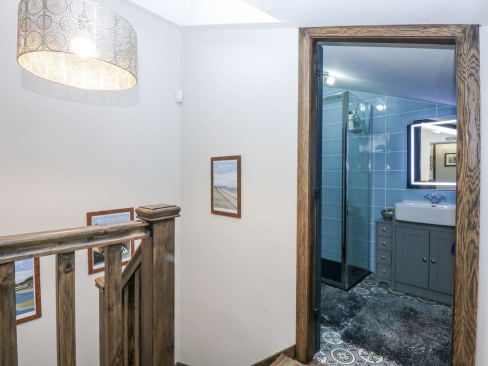 A bathroom entrance with a sink and shower at Windyridge in Gwaenysgor, near Prestatyn