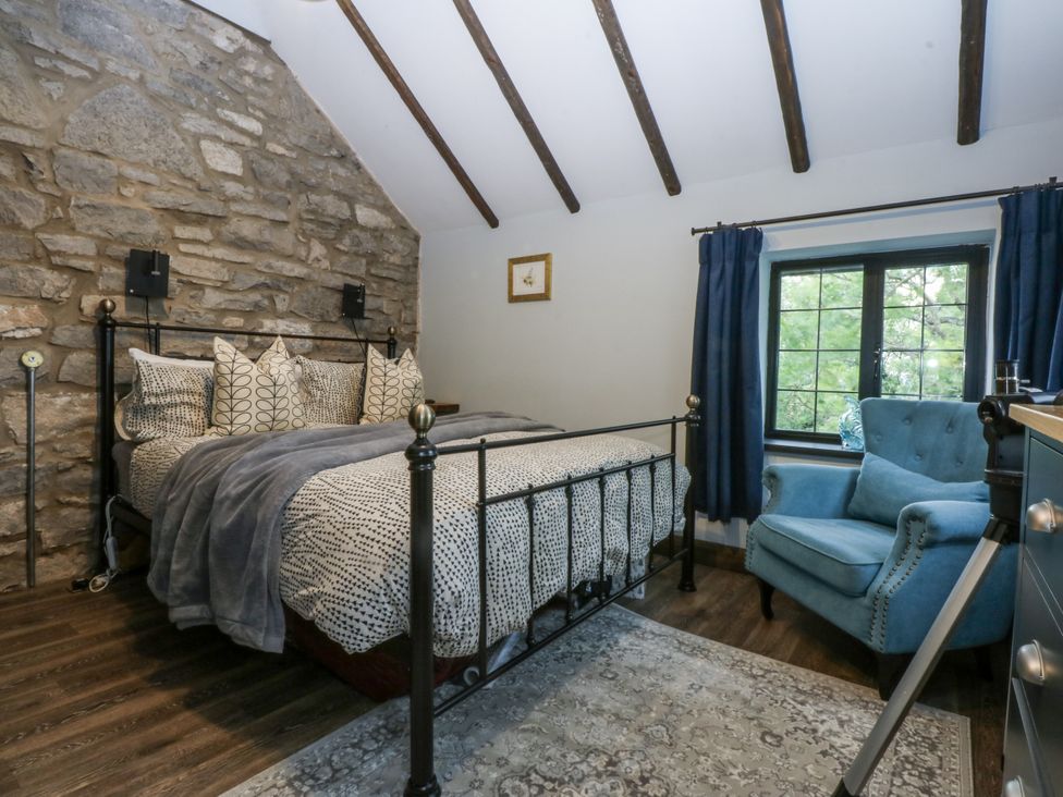 A bedroom with a bed and chair at Windyridge in Gwaenysgor, near Prestatyn