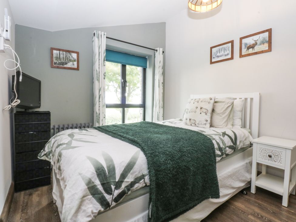 A bedroom with a bed and TV at Windyridge, Gwaenysgor, near Prestatyn