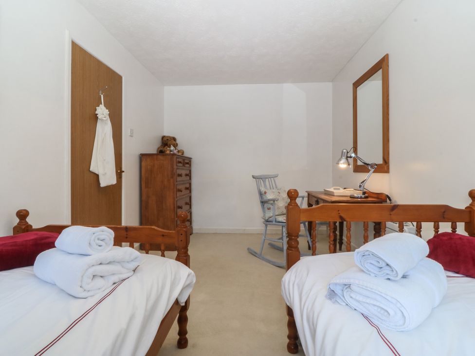 A bedroom with two beds and a dresser at Wingelock in Rhosneigr