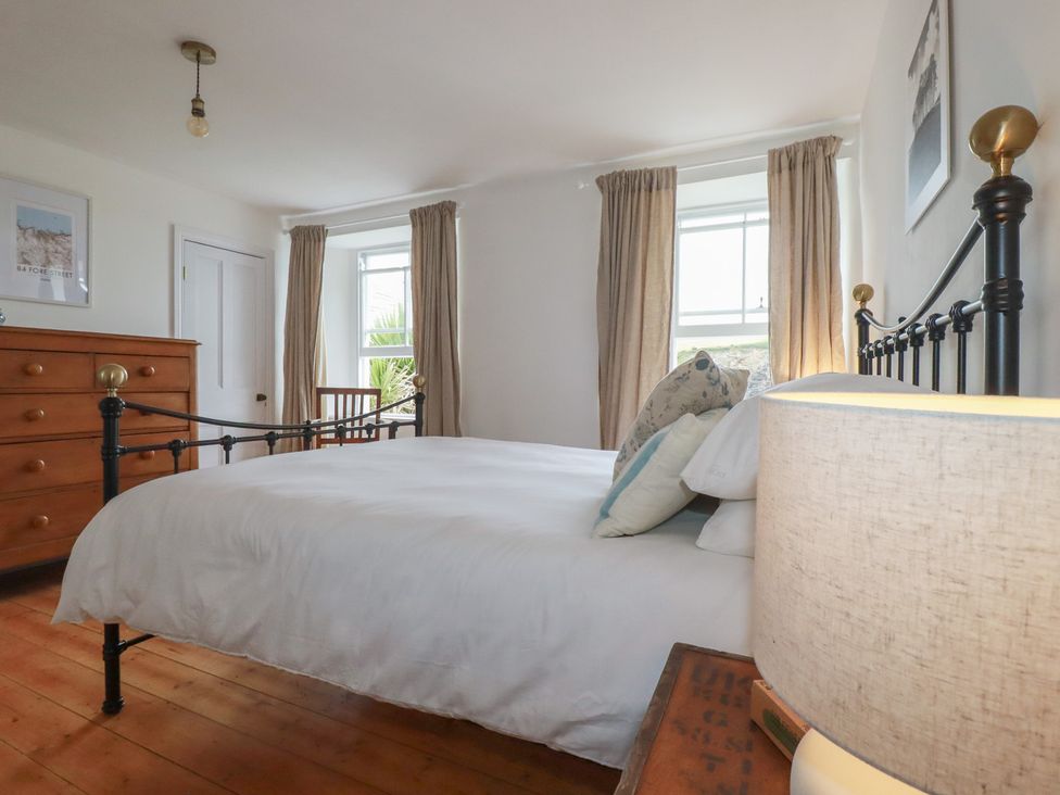 A bedroom with a bed and wooden furniture at 84 Fore Street