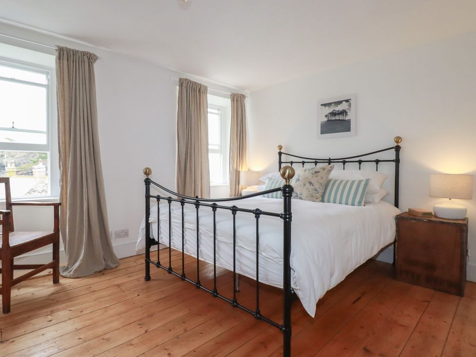 A bedroom with a bed and bedside table at 84 Fore Street