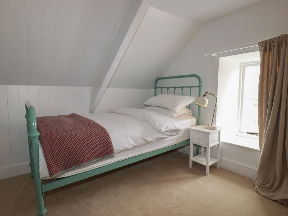 A bedroom with a bed and nightstand at 84 Fore Street