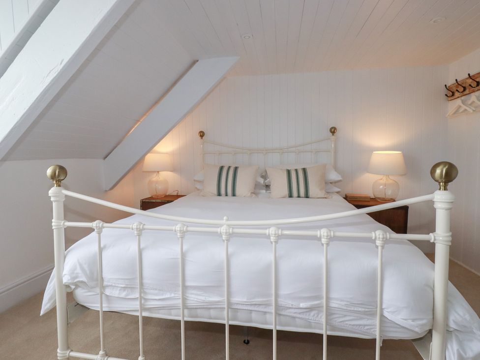 A bedroom with a bed and nightstands at 84 Fore Street