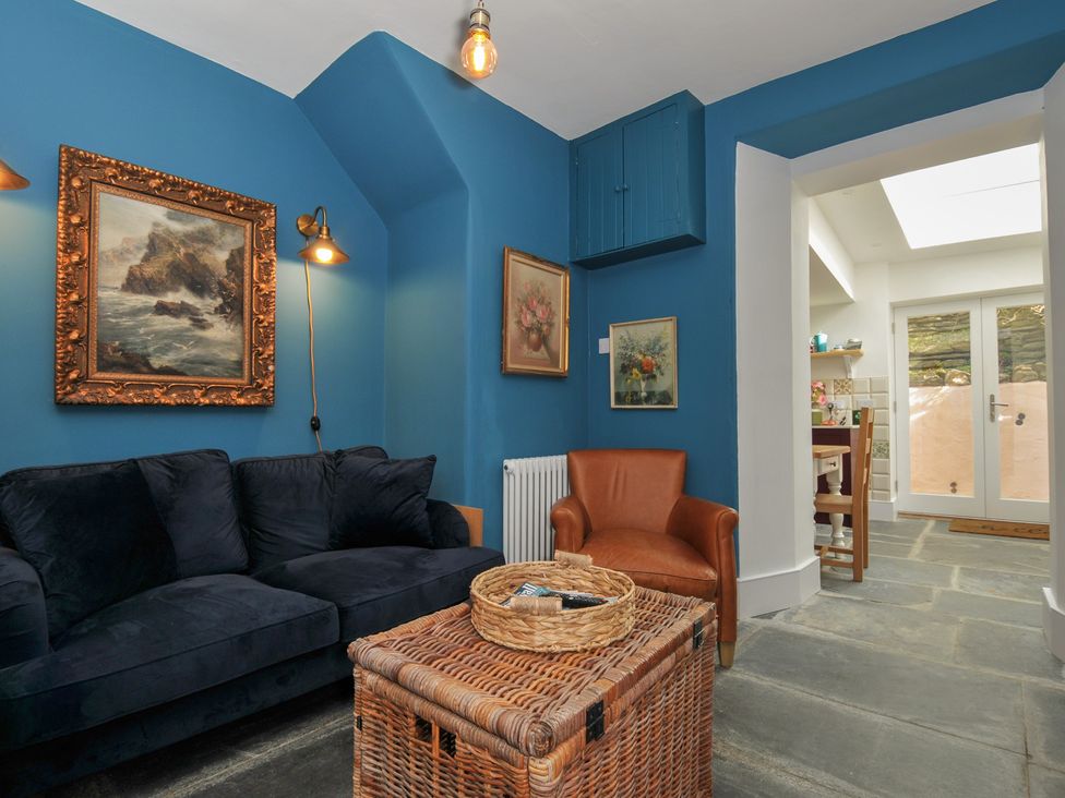 A snug with a sofa and armchair at 84 Fore Street in Port Isaac