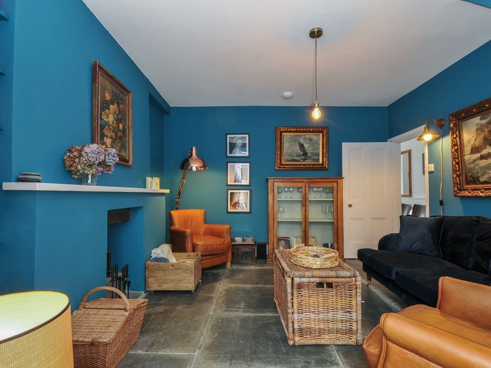 A living room with furniture and artwork at 84 Fore Street in Port Isaac