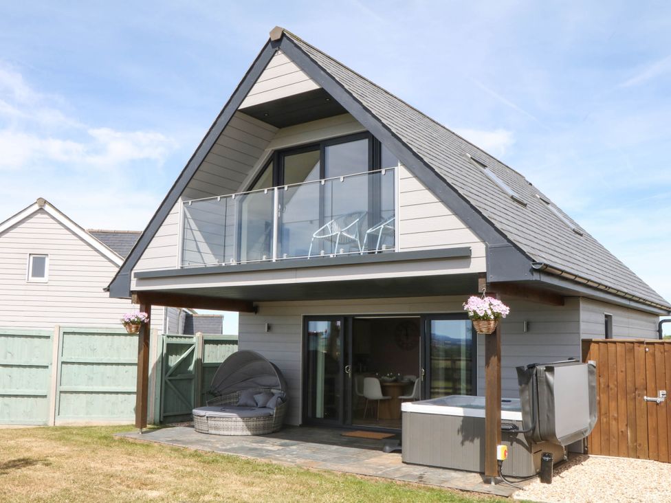 A house with a balcony and hot tub at Harescombe Lodge Morchard Bishop