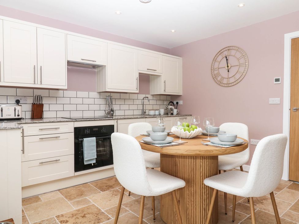 A kitchen with a dining table and chairs at Harescombe Lodge Morchard Bishop