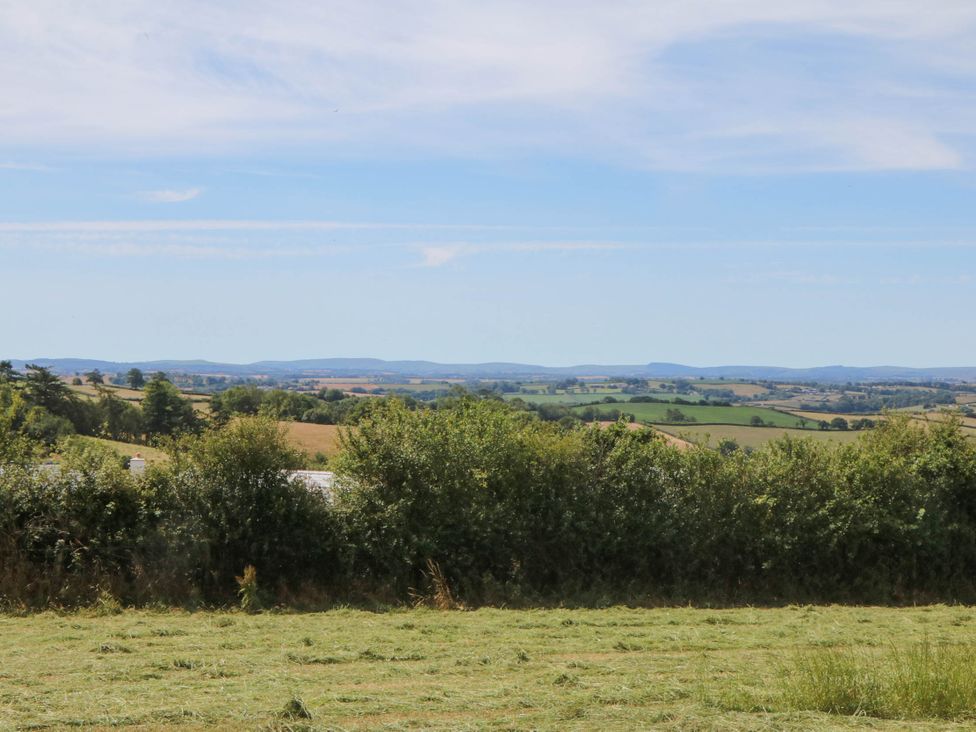 A landscape view with fields and trees at Harescombe Lodge in Morchard Bishop