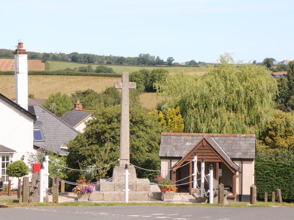 A cross and building in a rural setting at Harescombe Lodge in Morchard Bishop