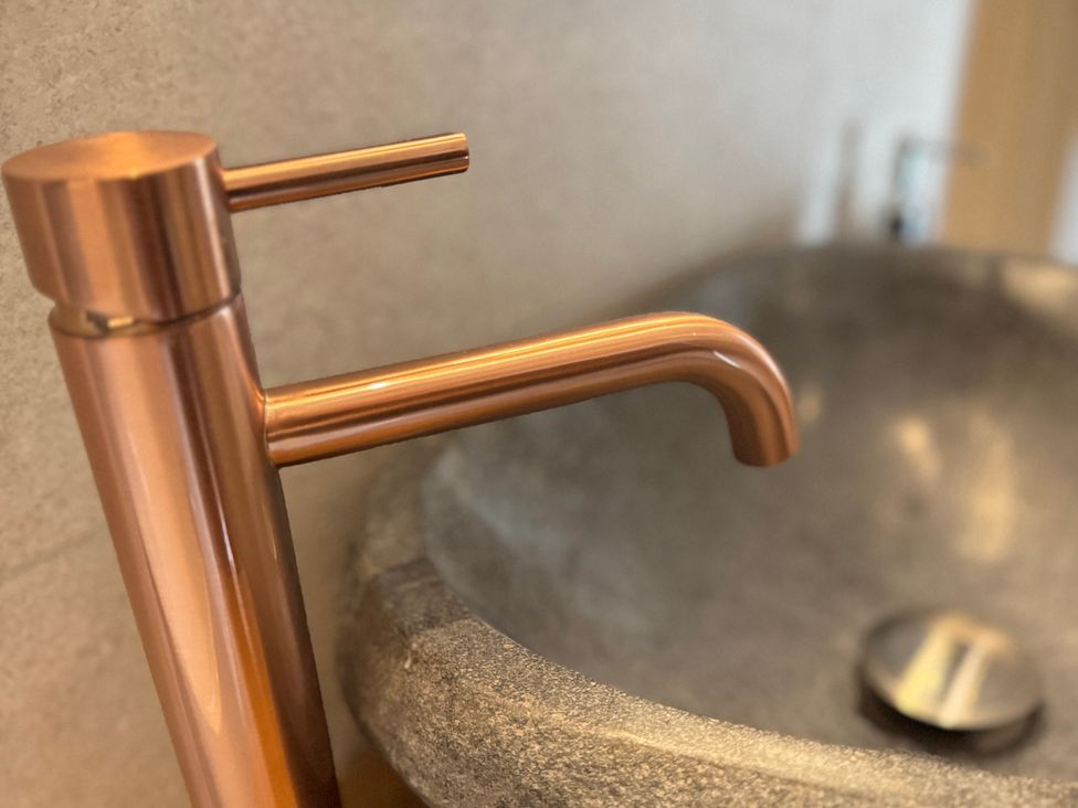 A faucet and sink in a bathroom at Railway Cottage Penybontfawr