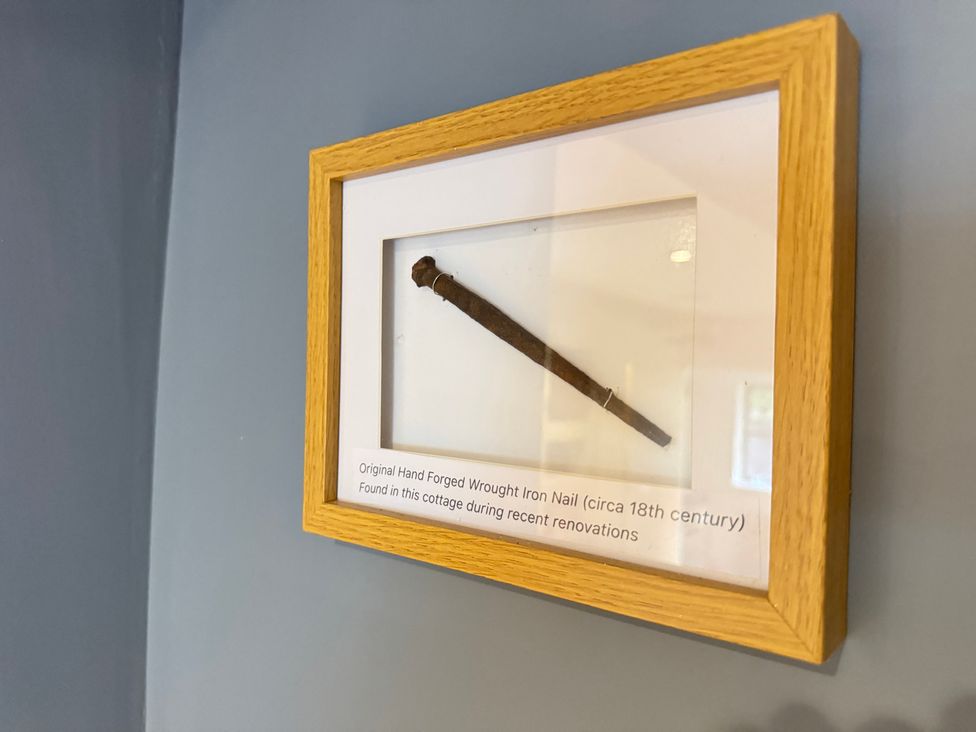 A framed original hand forged wrought iron nail at Railway Cottage in Penybontfawr